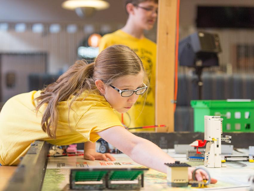 Young student at Eday exploring a lego display.